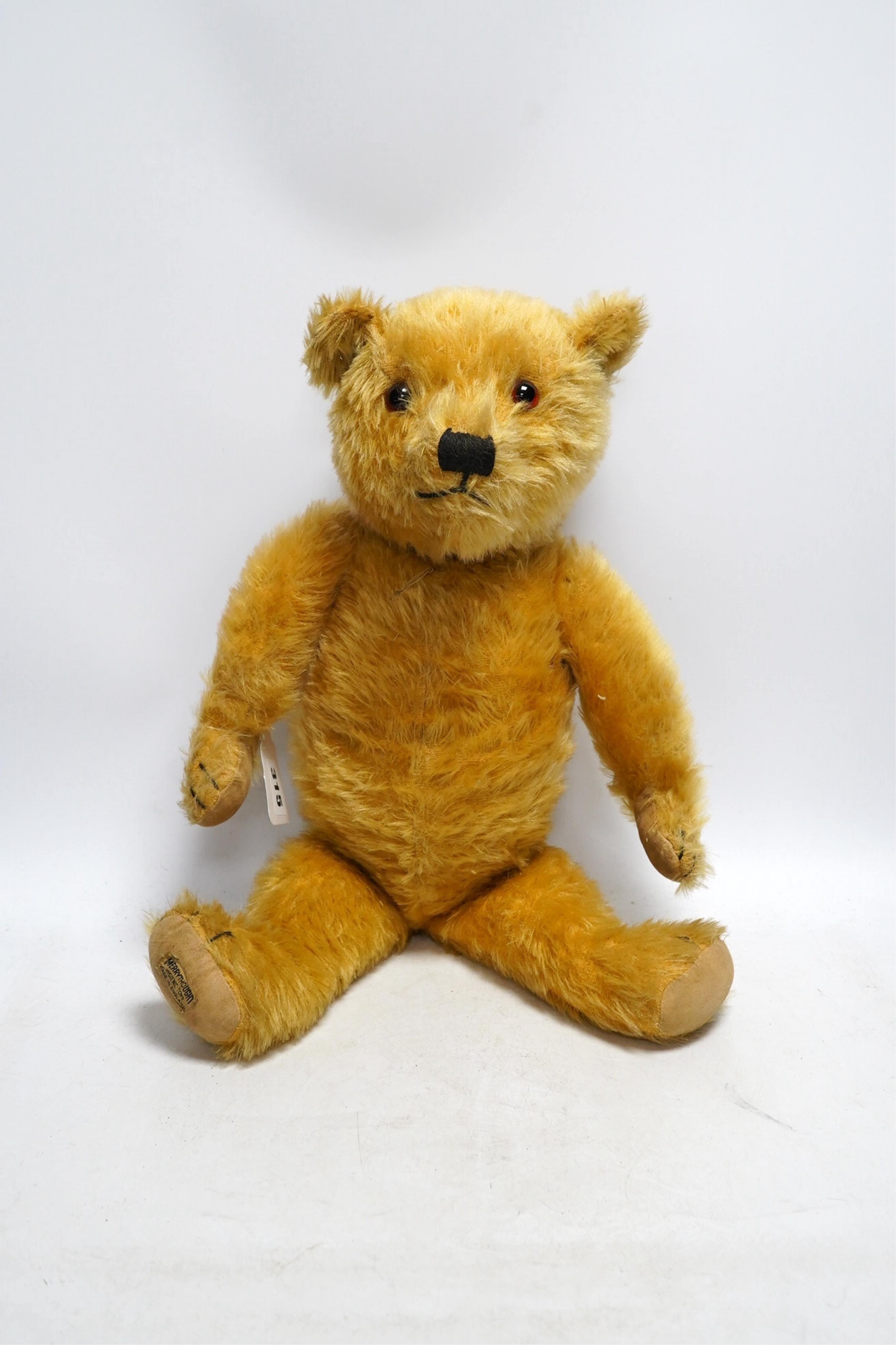 A large Chad Valley bear, c.1930's, label on foot, hair loss, restored paw pads, 69cm high, a Chad Valley red, white and blue unjointed bear, c.1950's, 60cm high, and a Merrythought bear c.1930's, label on foot, slight h